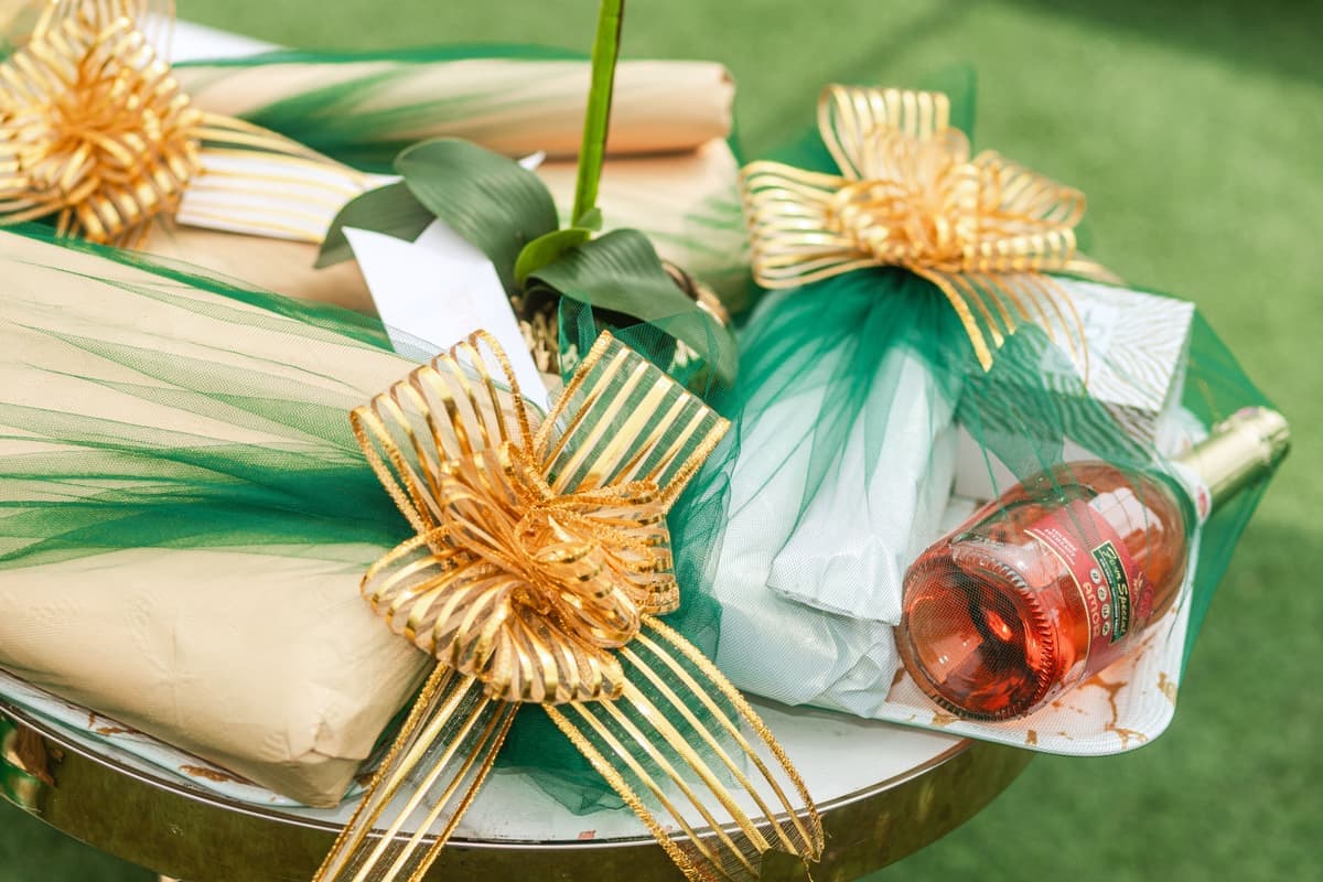 Wrapped gift box on an outdoor table beside a shaded garden seating area