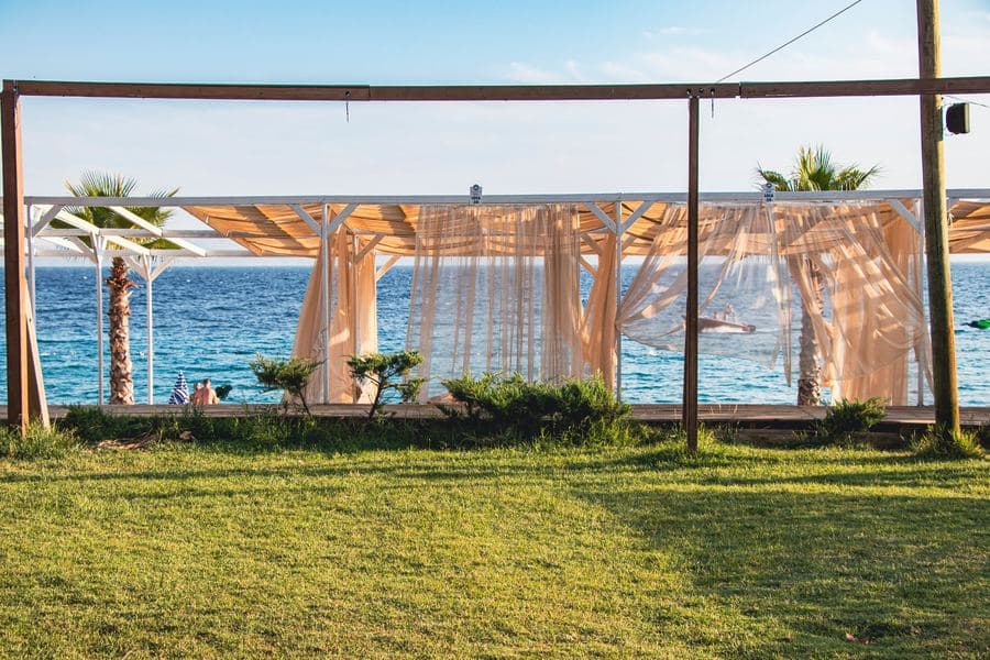 Gazebo with light curtains moving in the breeze looking out over open water