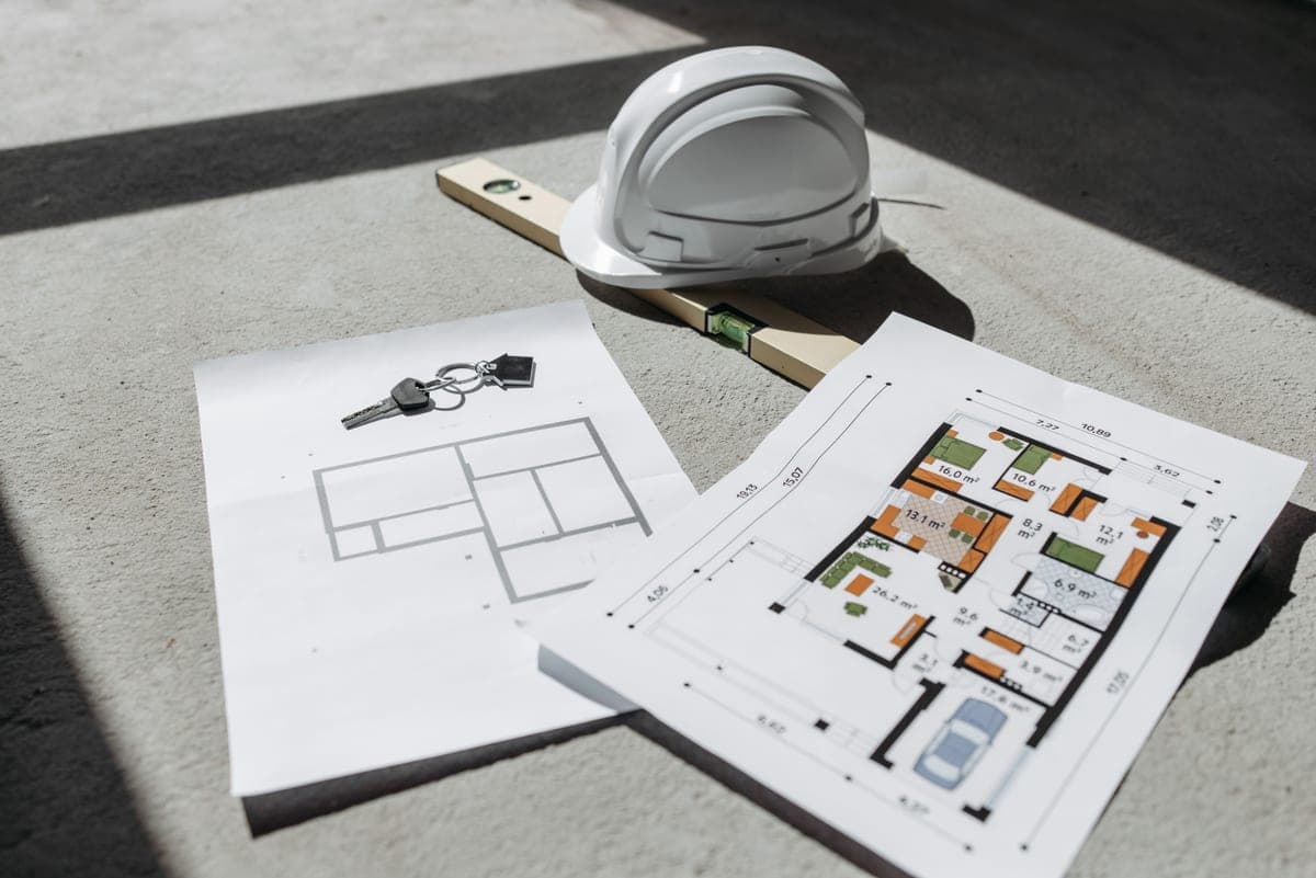 House plans and documents laid out on a table