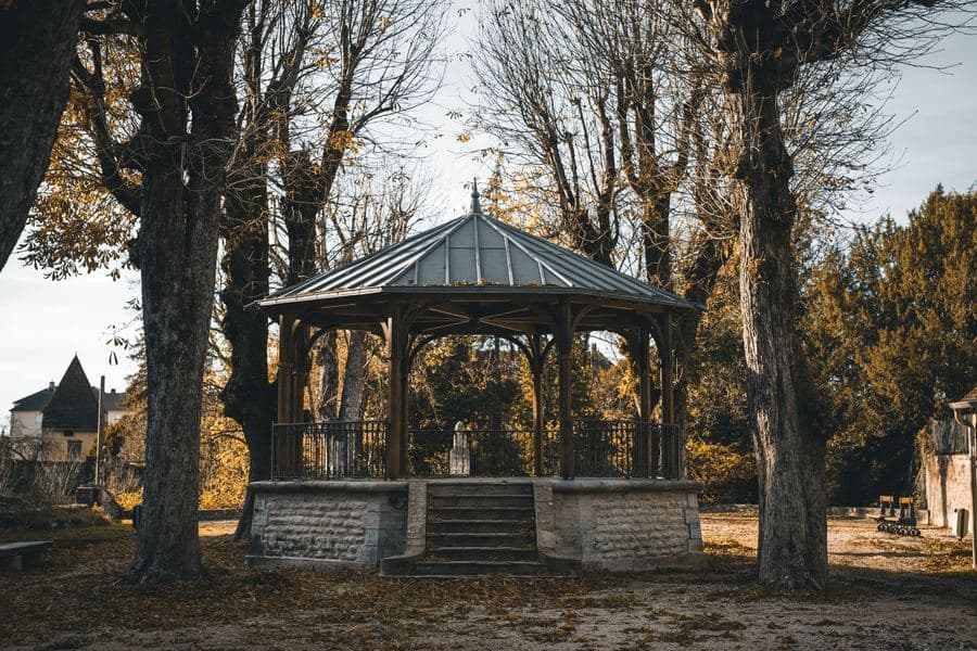 Backyard gazebo with a pitched galvanized metal roof over a paved seating area