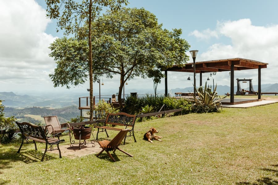Aluminum-framed gazebo with a two-tier galvanized steel roof over outdoor furniture