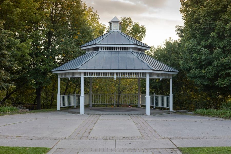 Hardtop gazebo with a galvanized steel roof and aluminum frame on a backyard patio