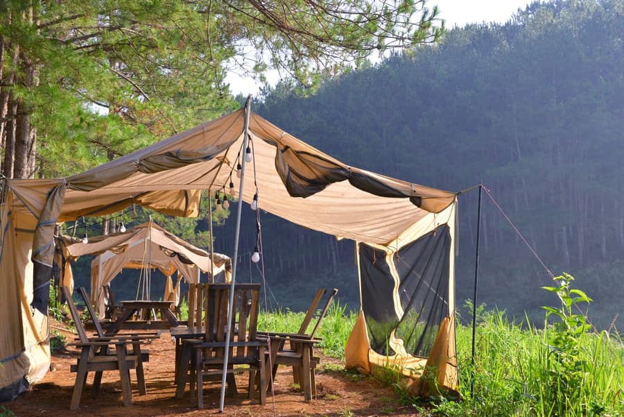 Heavy-duty pop-up canopy with an aluminum frame and reinforced legs on a paved surface