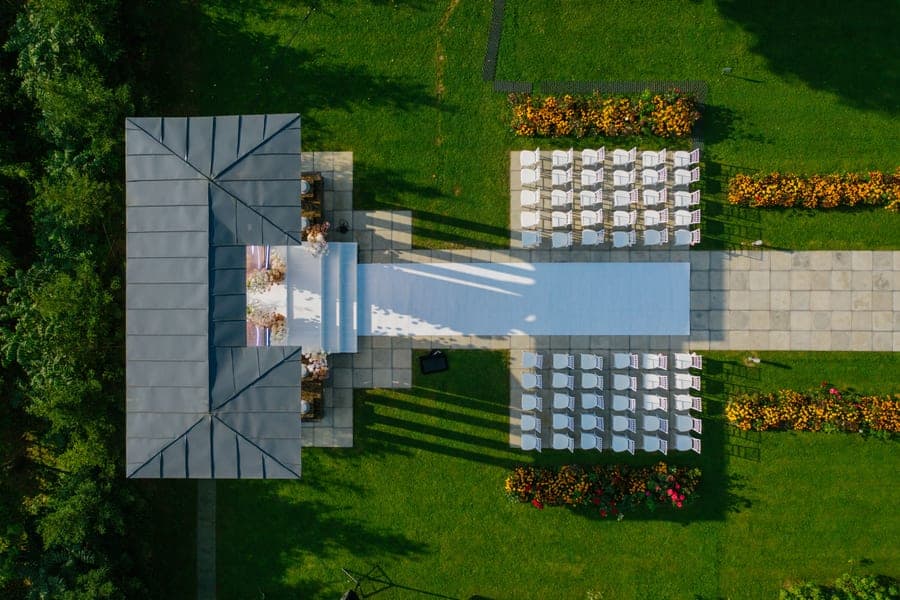 Aluminum-framed patio gazebo with a double-tier fabric roof, mesh netting and side curtains