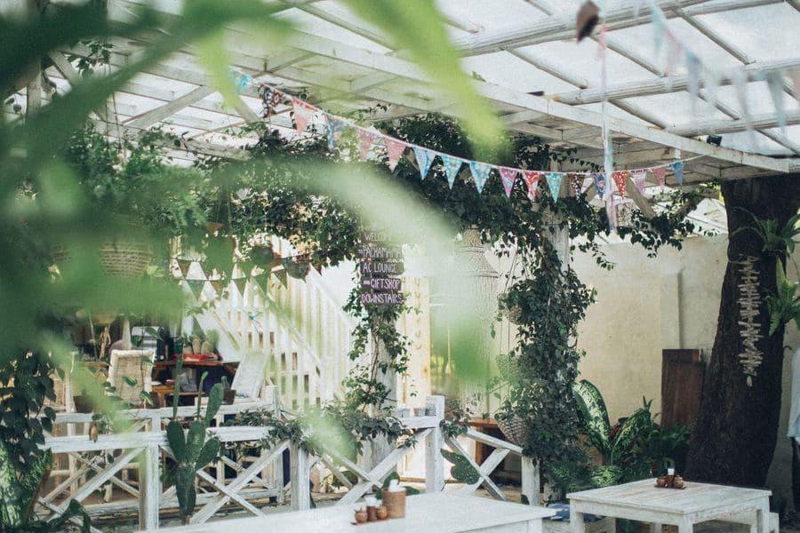 Aluminum pergola with a retractable fabric canopy partly drawn back over a patio