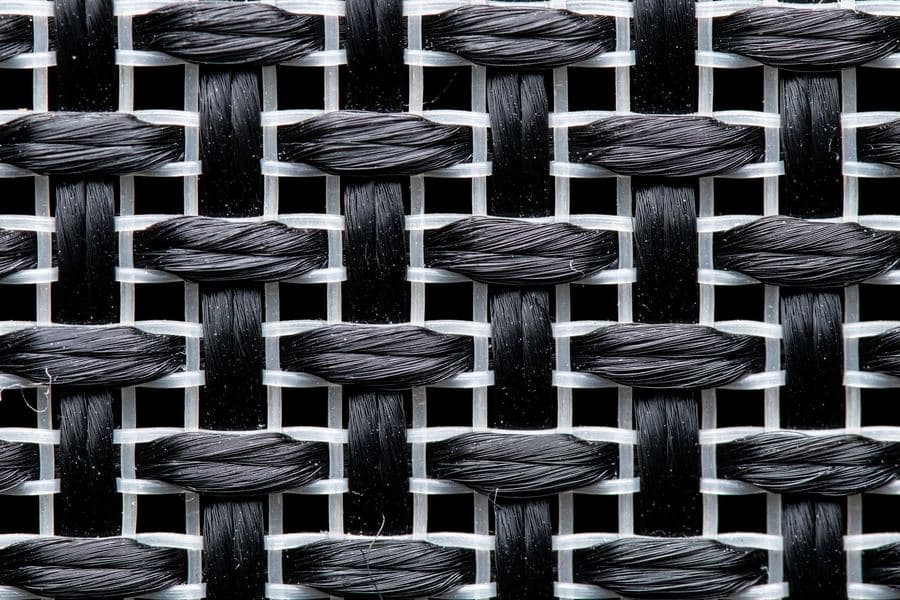 Close-up of dense knitted shade fabric showing the tape and monofilament weave