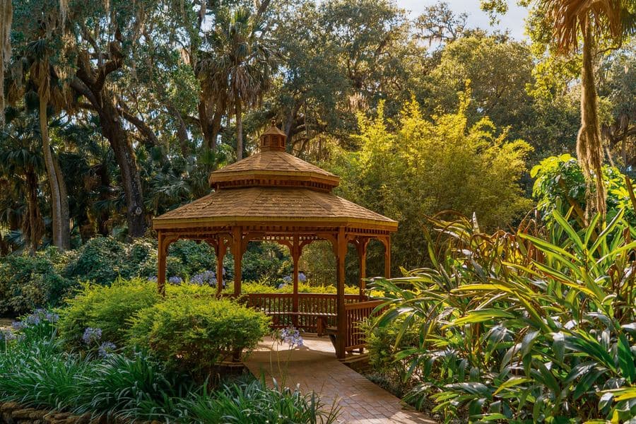 Soft-top garden gazebo with a two-tier fabric canopy and hanging mesh side panels
